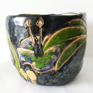 Blue ceramic plant pot with green palm leafs